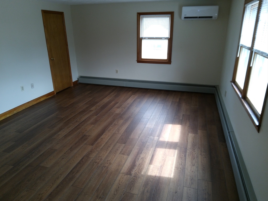 121 King Philip Road Worcester, MA 01606 - Photo 20 of 31 an empty room with wooden floor and windows