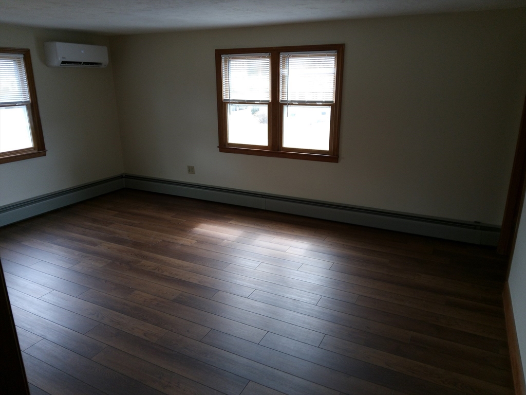 121 King Philip Road Worcester, MA 01606 - Photo 21 of 31 an empty room with wooden floor and windows