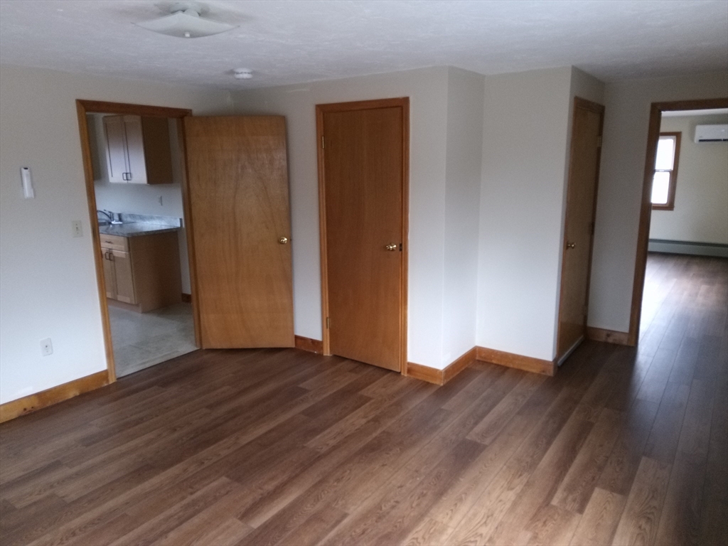 121 King Philip Road Worcester, MA 01606 - Photo 22 of 31 a view of a room with wooden floor and a kitchen