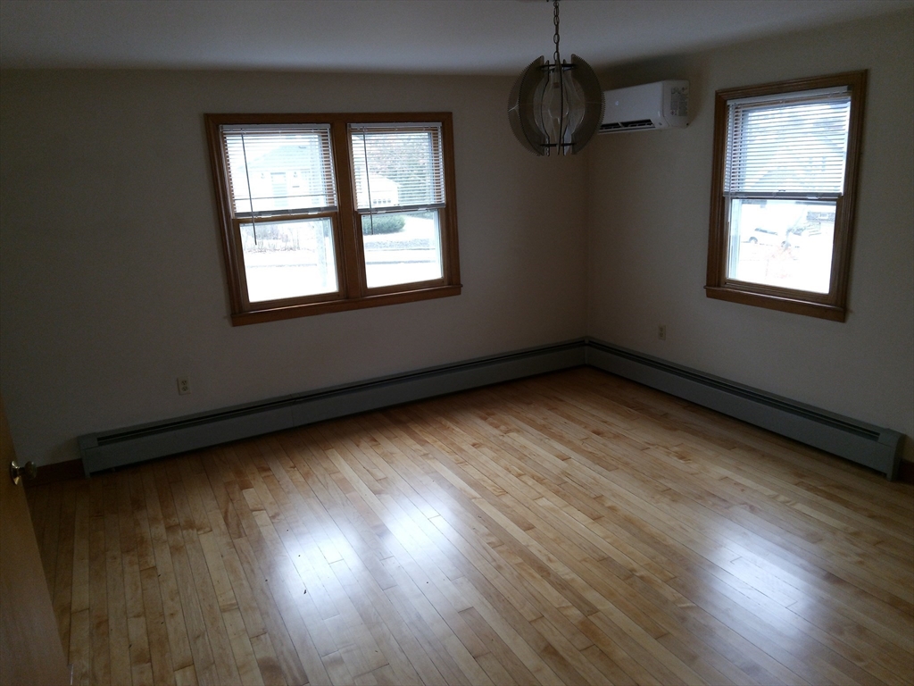 121 King Philip Road Worcester, MA 01606 - Photo 4 of 31 wooden floor in an empty room with a window