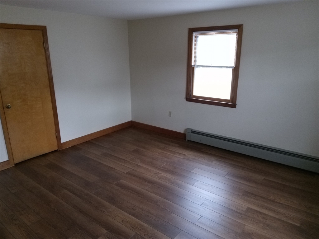 121 King Philip Road Worcester, MA 01606 - Photo 6 of 31 an empty room with wooden floor and windows