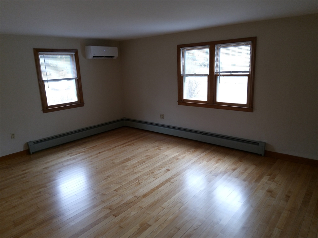 121 King Philip Road Worcester, MA 01606 - Photo 7 of 31 an empty room with wooden floor and windows