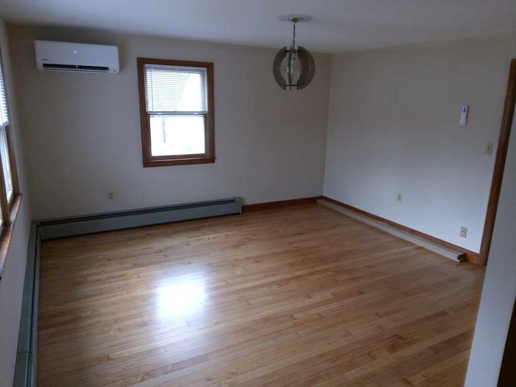 121 King Philip Road Worcester, MA 01606 - Photo 10 of 31 an empty room with wooden floor and windows