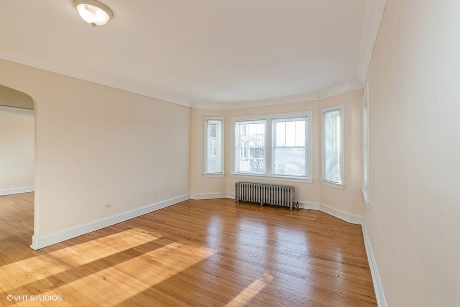 10981 South Church Street, Unit 3B Chicago, IL 60643 - Photo 2 of 8 a view of an empty room with wooden floor and a window