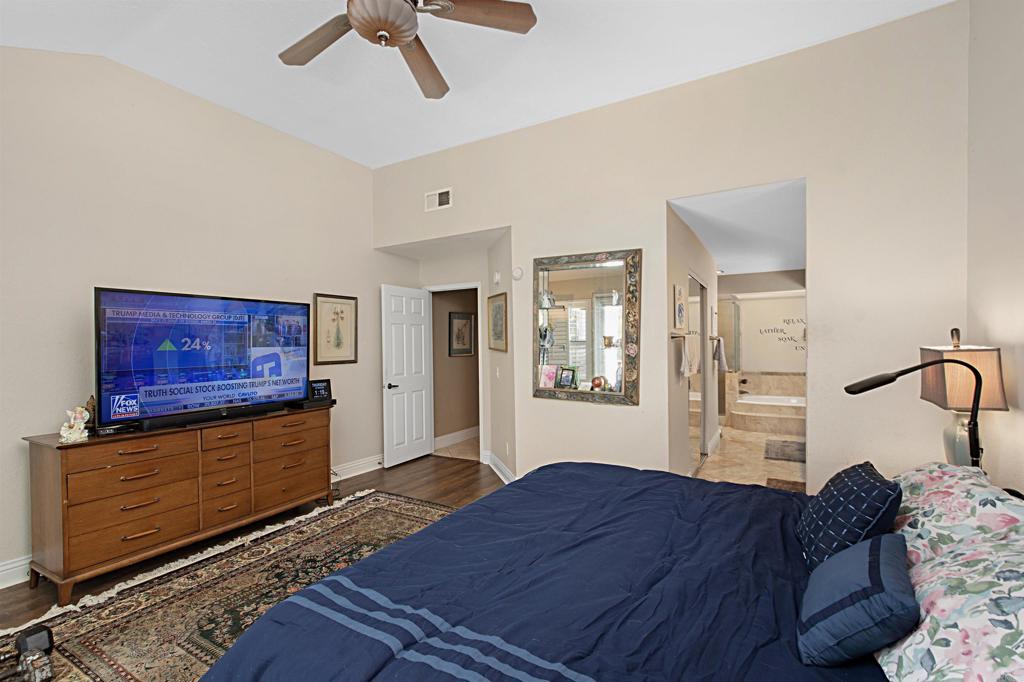 2046 Balboa Circle Vista, CA 92081 - Photo 11 of 37 a bedroom with a bed and wooden floor