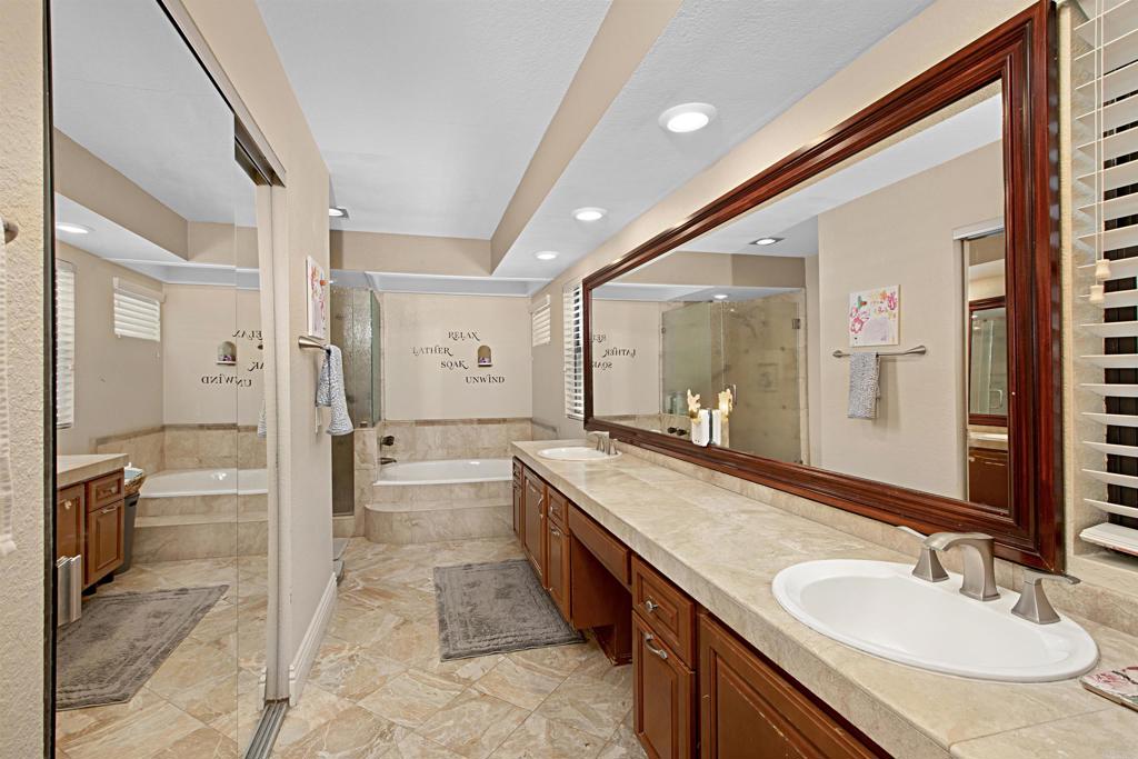 2046 Balboa Circle Vista, CA 92081 - Photo 12 of 37 a spacious bathroom with a granite countertop sink mirror and a bath tub