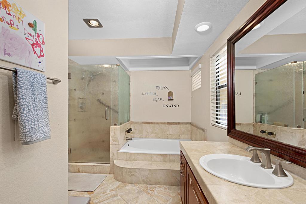 2046 Balboa Circle Vista, CA 92081 - Photo 13 of 37 a bathroom with a tub sink and mirror