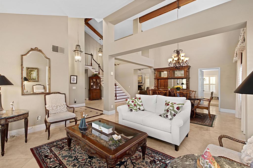 2046 Balboa Circle Vista, CA 92081 - Photo 14 of 37 a living room with furniture a rug and a chandelier
