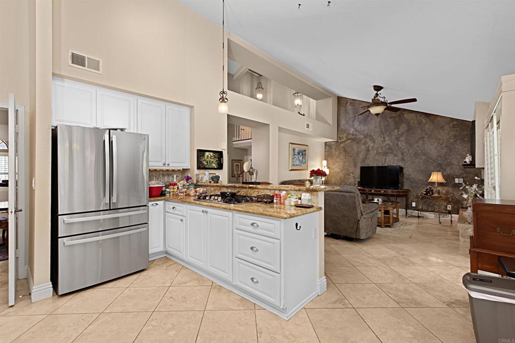 2046 Balboa Circle Vista, CA 92081 - Photo 21 of 37 a kitchen with stainless steel appliances a stove refrigerator and cabinets