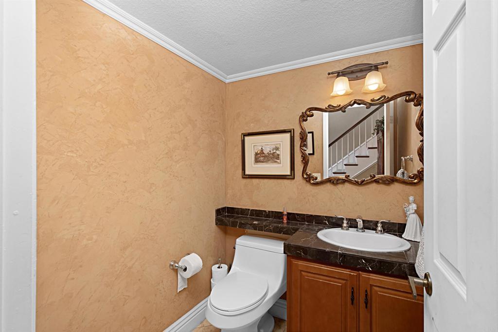 2046 Balboa Circle Vista, CA 92081 - Photo 22 of 37 a bathroom with a toilet a sink and mirror