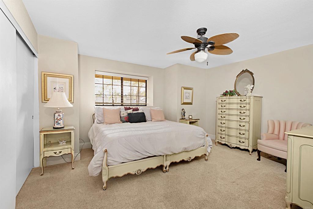 2046 Balboa Circle Vista, CA 92081 - Photo 23 of 37 a bedroom with a bed and a chandelier