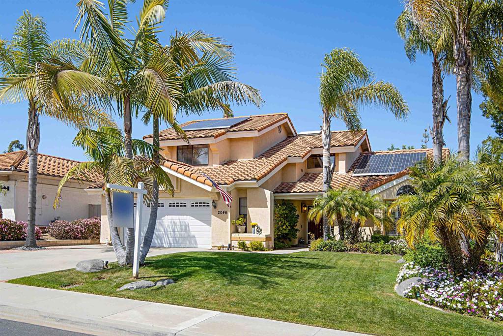2046 Balboa Circle Vista, CA 92081 - Photo 3 of 37 a front view of a house with a garden and a yard