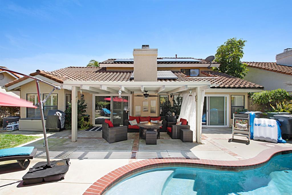 2046 Balboa Circle Vista, CA 92081 - Photo 36 of 37 a view of a patio with table and chairs potted plants and a palm tree