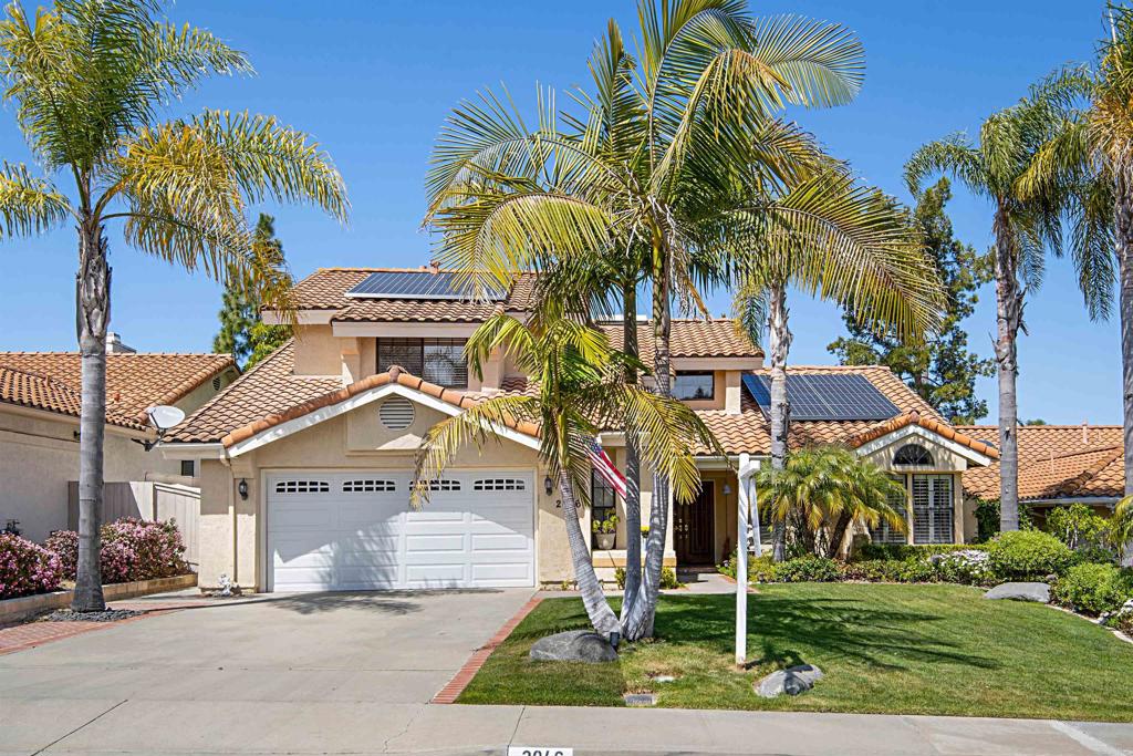 2046 Balboa Circle Vista, CA 92081 - Photo 4 of 37 a view of a house with a yard and palm trees