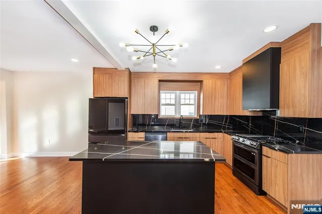 a view of kitchen with kitchen island refrigerator stove microwave and cabinets