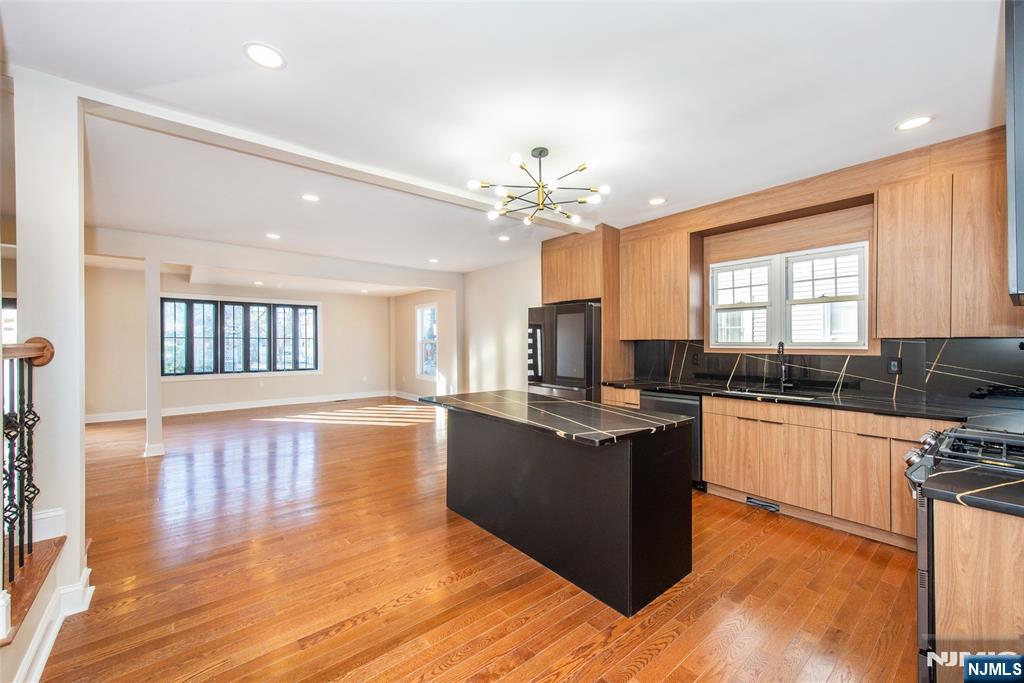 50 Grand Avenue Ridgefield Park, NJ 07660 - Photo 17 of 36 a large kitchen with kitchen island a sink wooden floor and stainless steel appliances