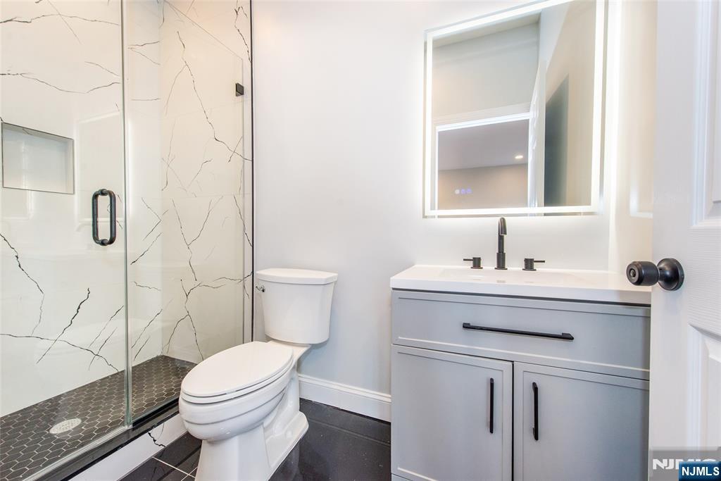 50 Grand Avenue Ridgefield Park, NJ 07660 - Photo 19 of 36 a bathroom with a sink a toilet and shower