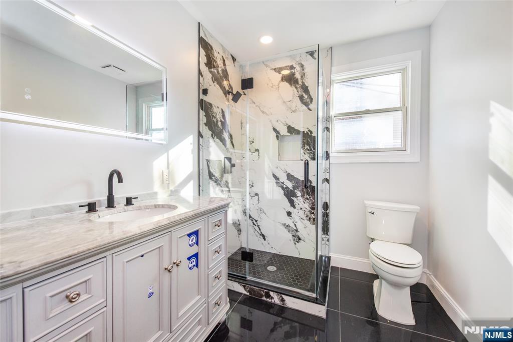 50 Grand Avenue Ridgefield Park, NJ 07660 - Photo 22 of 36 a spacious bathroom with a granite countertop sink toilet and shower