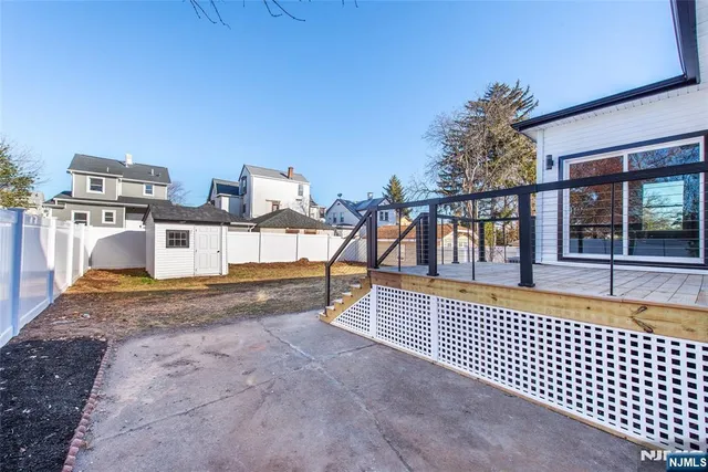 a view of house with a large windows and a ceiling fan