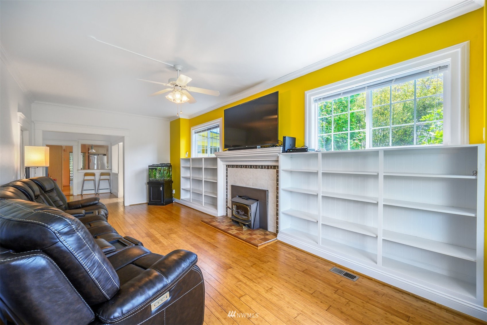 2313 Rucker Avenue Everett, WA 98201 - Photo 10 of 35 a living room with furniture a fireplace and a flat screen tv