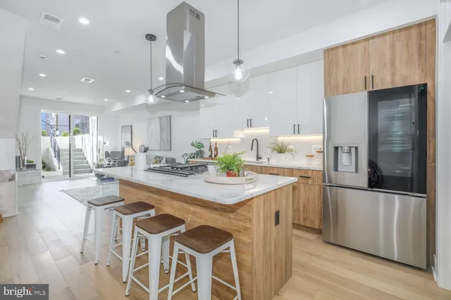 a living room with furniture and a view of kitchen
