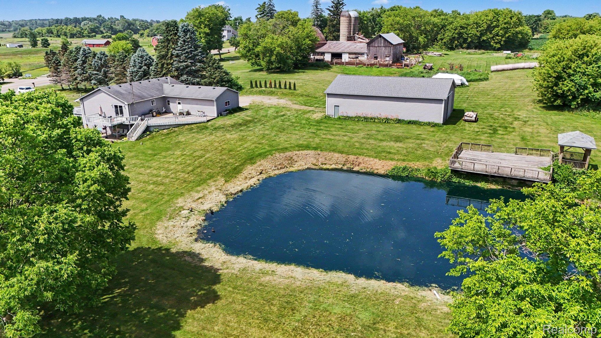 4848 Columbiaville Road Columbiaville, MI 48421 - Photo 32 of 35 Expansive natural pond featuring a dock and covered structure