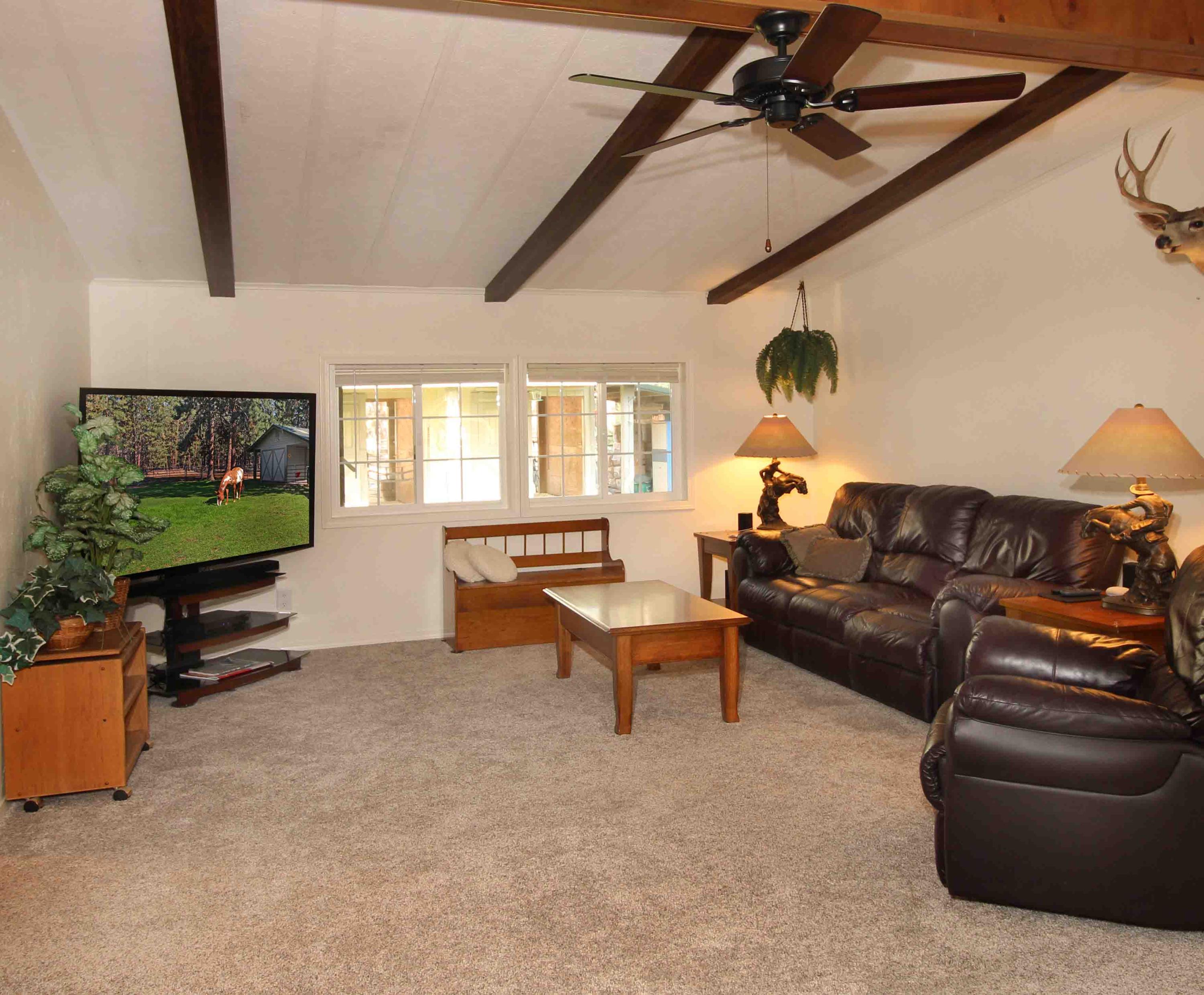 60076 Turquoise Road Bend, OR 97702 - Photo 19 of 43 Vaulted living room with wood accented beams, ceiling fan,
