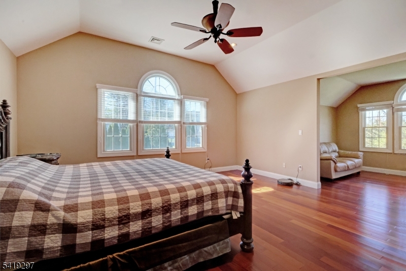 24 Pine Brook Road Montville, NJ 07082 - Photo 11 of 27 a bedroom with a bed and a chandelier
