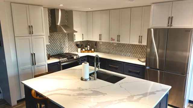 a kitchen with stainless steel appliances kitchen island granite countertop a refrigerator a sink and a stove