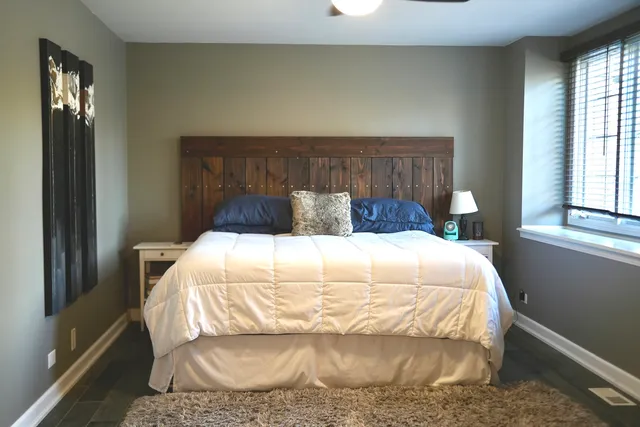 a view of a hallway with staircase and white walls
