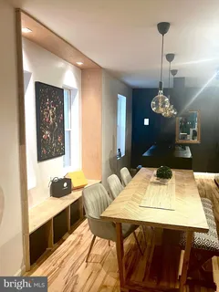 a dining room with a table chairs and kitchen view