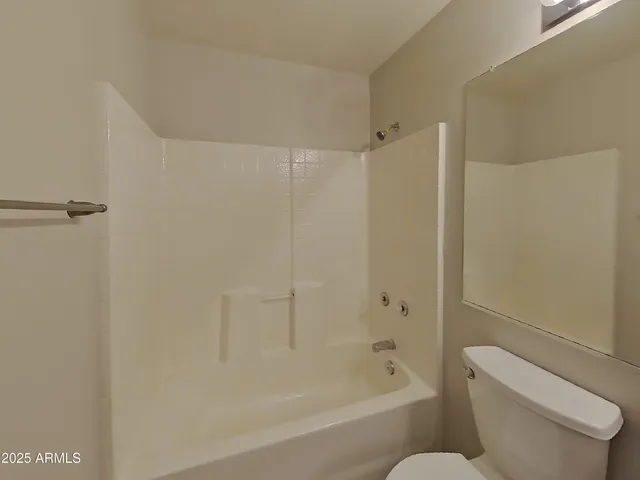 a view of a brick house with a door and chair