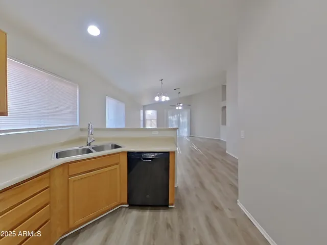 a kitchen with a sink cabinets and wooden floor