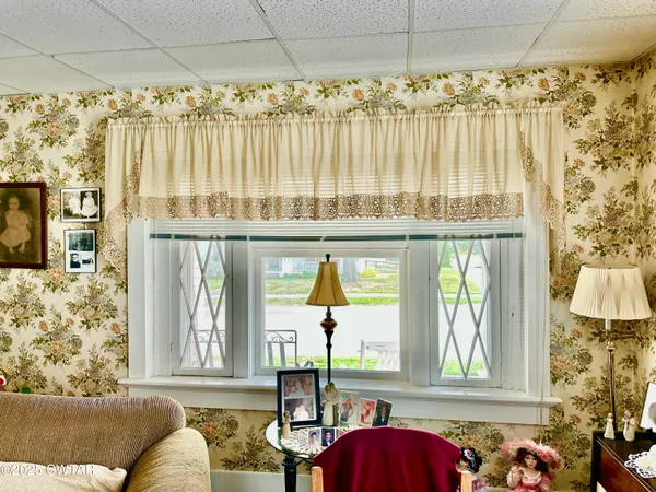 a view of a dining room with furniture and a window