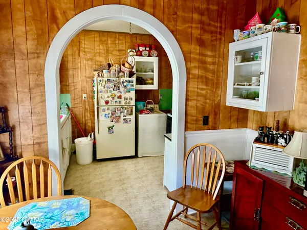 a kitchen with a refrigerator and a stove top oven