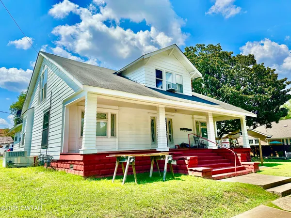 a front view of house with yard and outdoor seating
