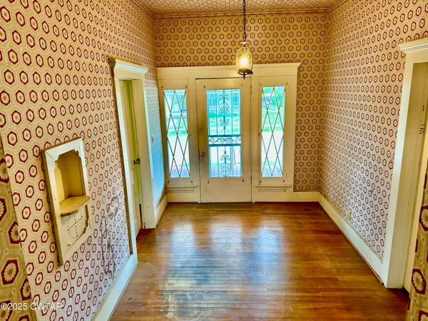 a view of an entryway door with wooden floor