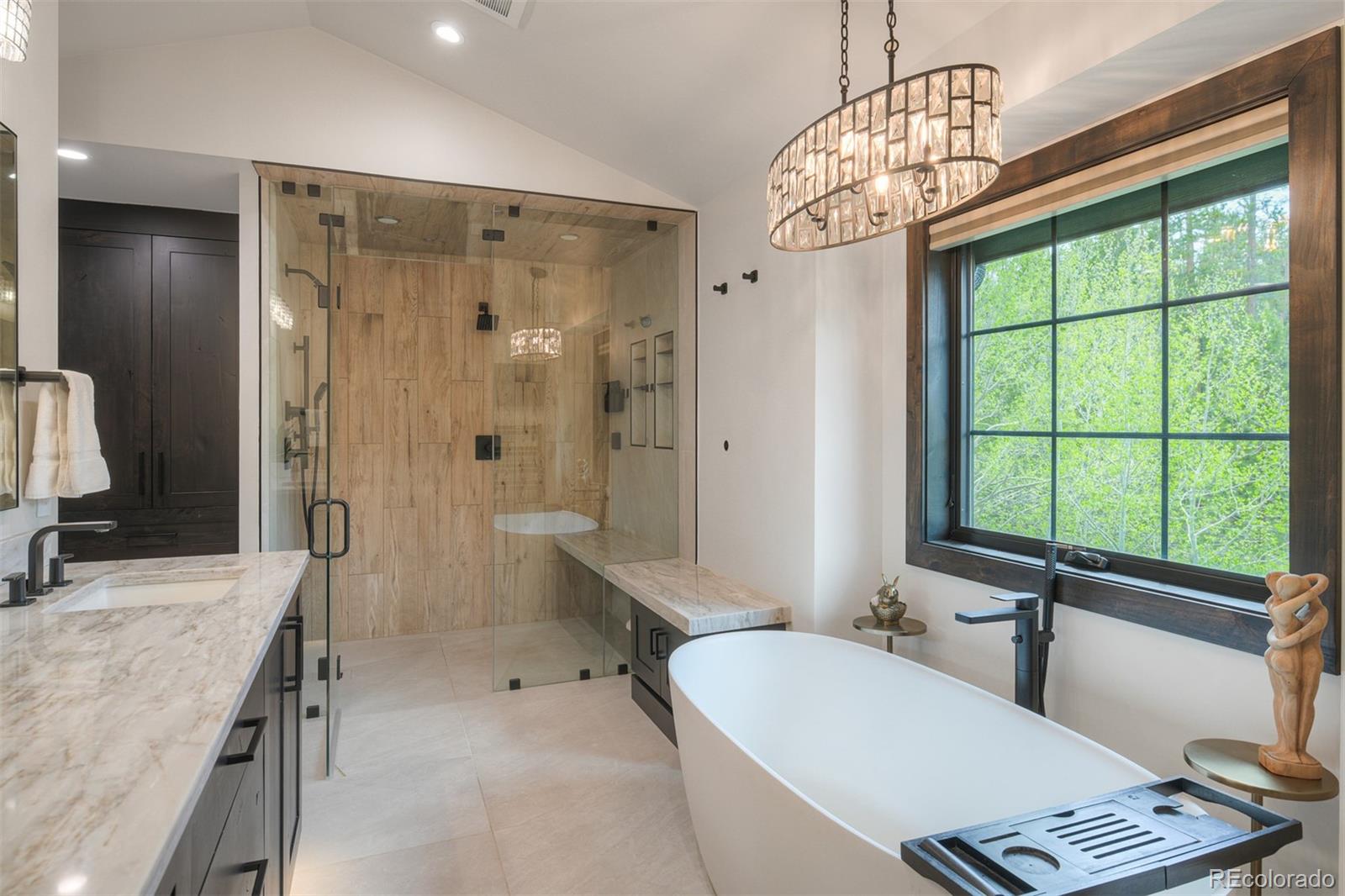 306 Golden Eagle Road Silverthorne, CO 80498 - Photo 21 of 43 a bathroom with a double vanity sink bathtub and next to a window