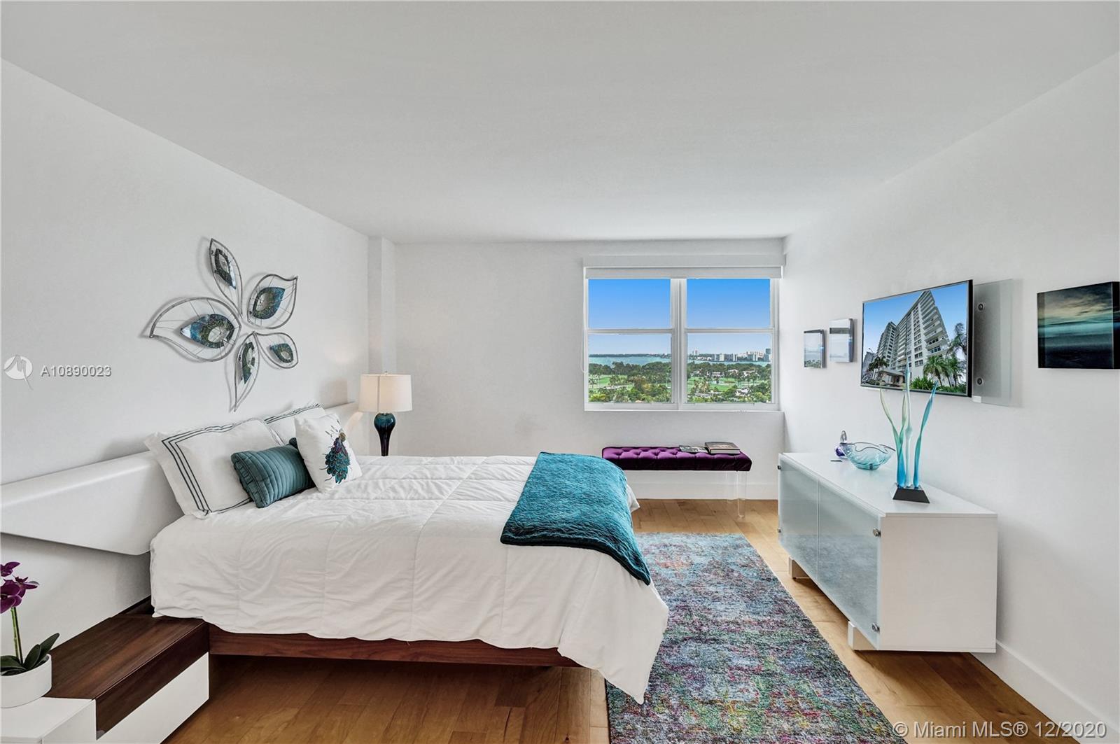 5750 Collins Avenue, Unit 15F Miami Beach, FL 33140 - Photo 15 of 65 a bedroom with a large bed and a couch