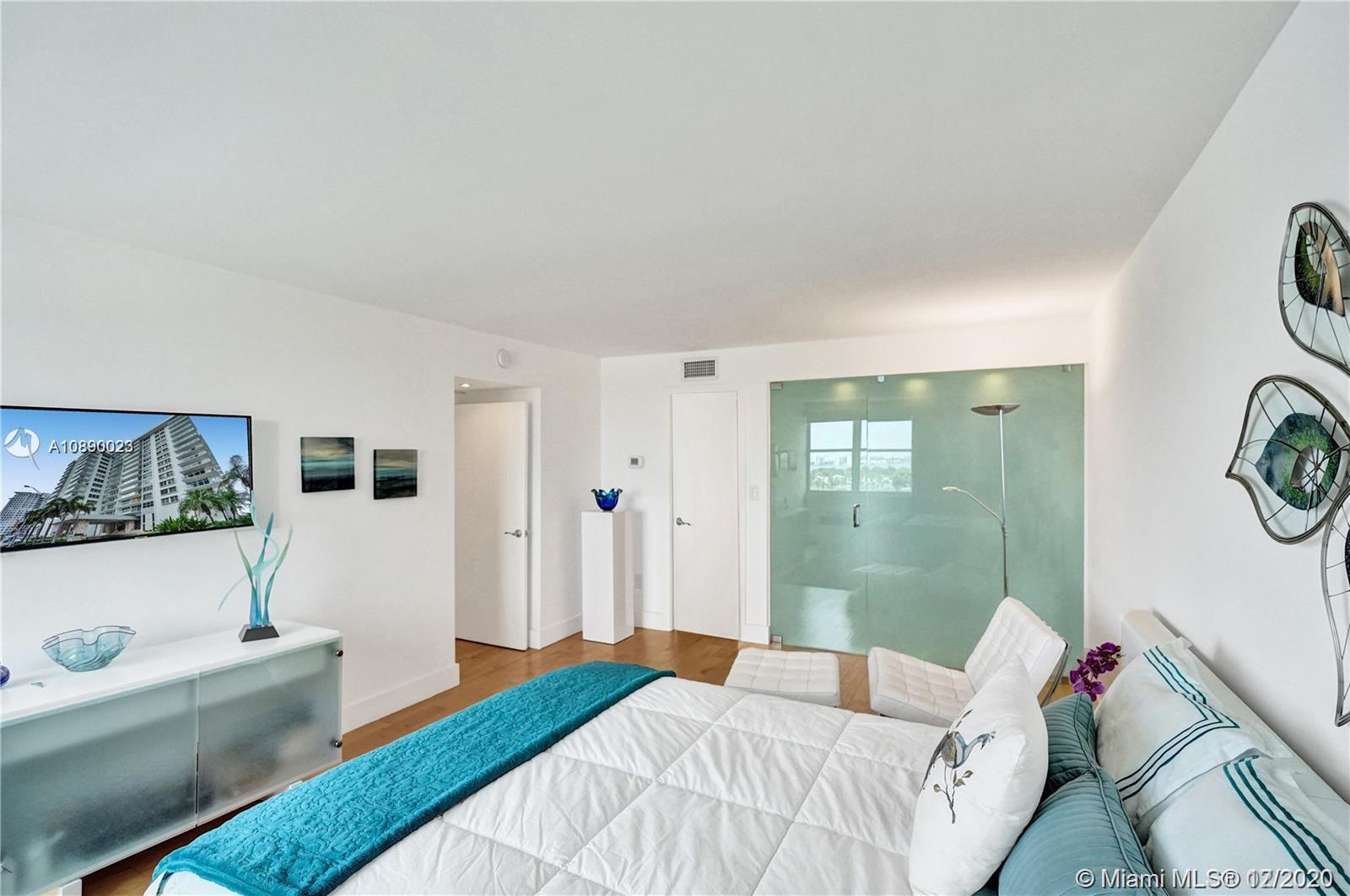 5750 Collins Avenue, Unit 15F Miami Beach, FL 33140 - Photo 16 of 65 a bedroom with a bed and a window