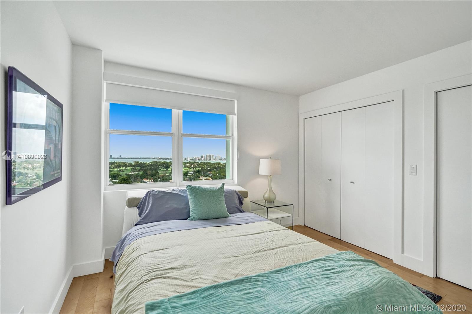 5750 Collins Avenue, Unit 15F Miami Beach, FL 33140 - Photo 17 of 65 a bedroom with a large bed and a large window