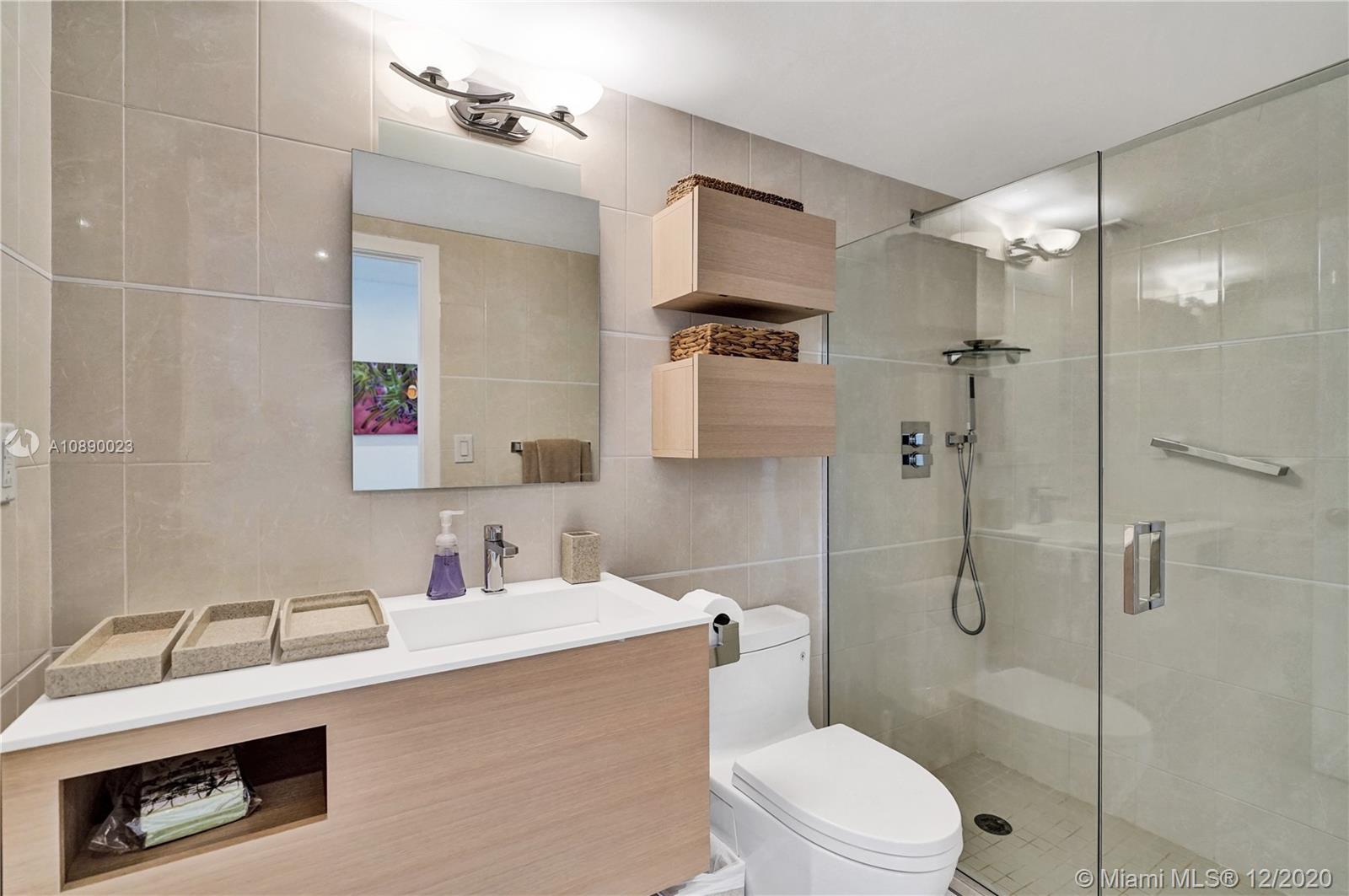 5750 Collins Avenue, Unit 15F Miami Beach, FL 33140 - Photo 18 of 65 a bathroom with a sink a toilet and shower