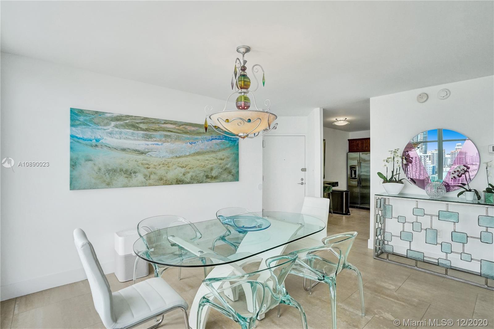 5750 Collins Avenue, Unit 15F Miami Beach, FL 33140 - Photo 23 of 65 a view of a dining room with furniture and wooden floor