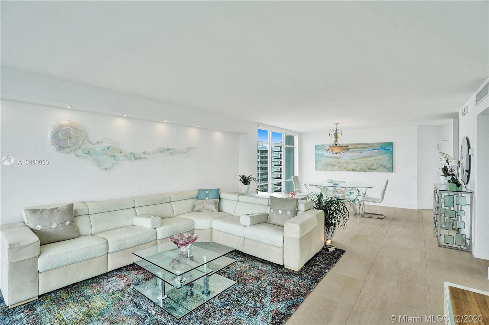 5750 Collins Avenue, Unit 15F Miami Beach, FL 33140 - Photo 25 of 65 a living room with furniture and a table