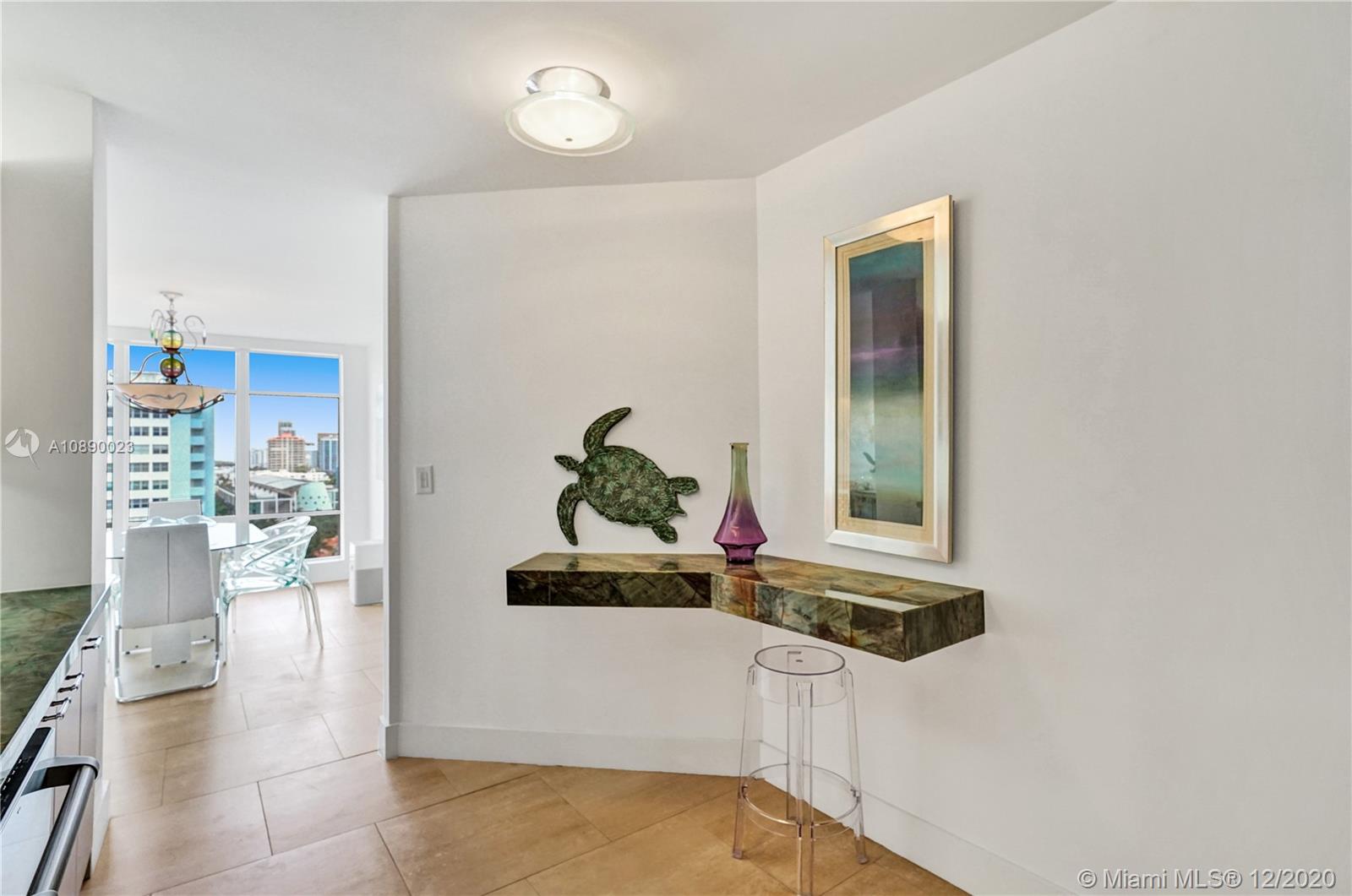5750 Collins Avenue, Unit 15F Miami Beach, FL 33140 - Photo 27 of 65 a dining room with furniture and a potted plant