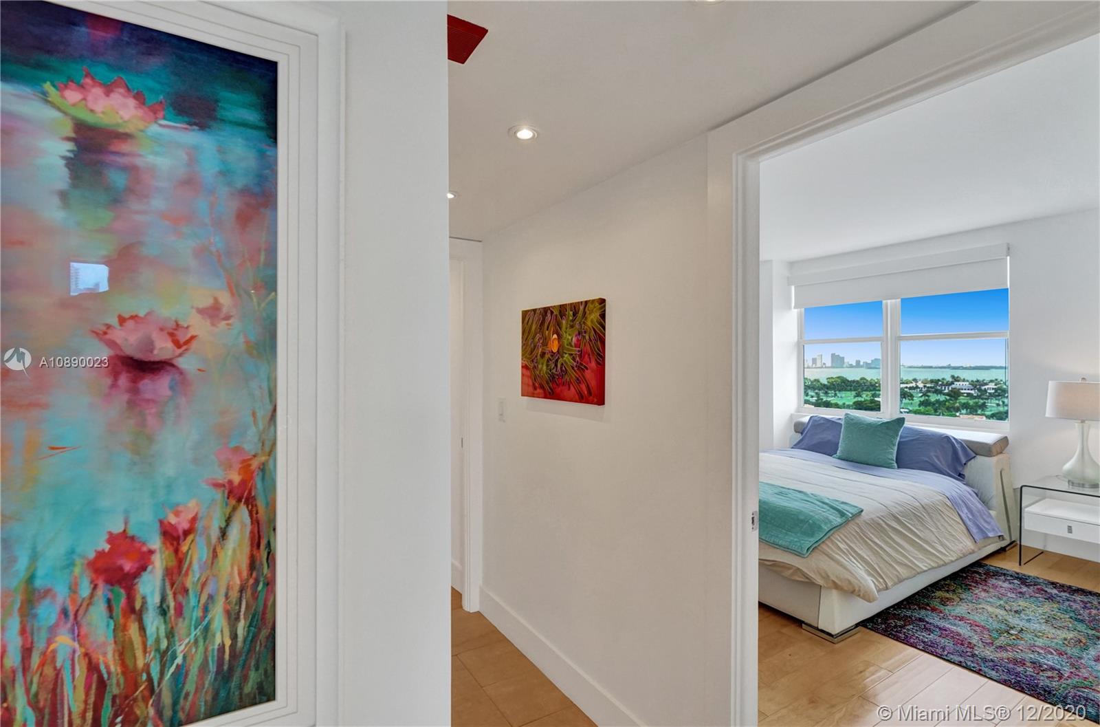 5750 Collins Avenue, Unit 15F Miami Beach, FL 33140 - Photo 28 of 65 a bed room with a bed and a painting on the wall