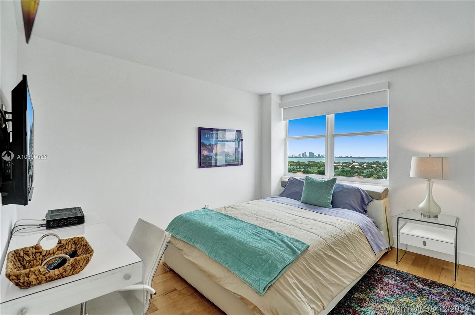 5750 Collins Avenue, Unit 15F Miami Beach, FL 33140 - Photo 29 of 65 a bedroom with a bed and a couch