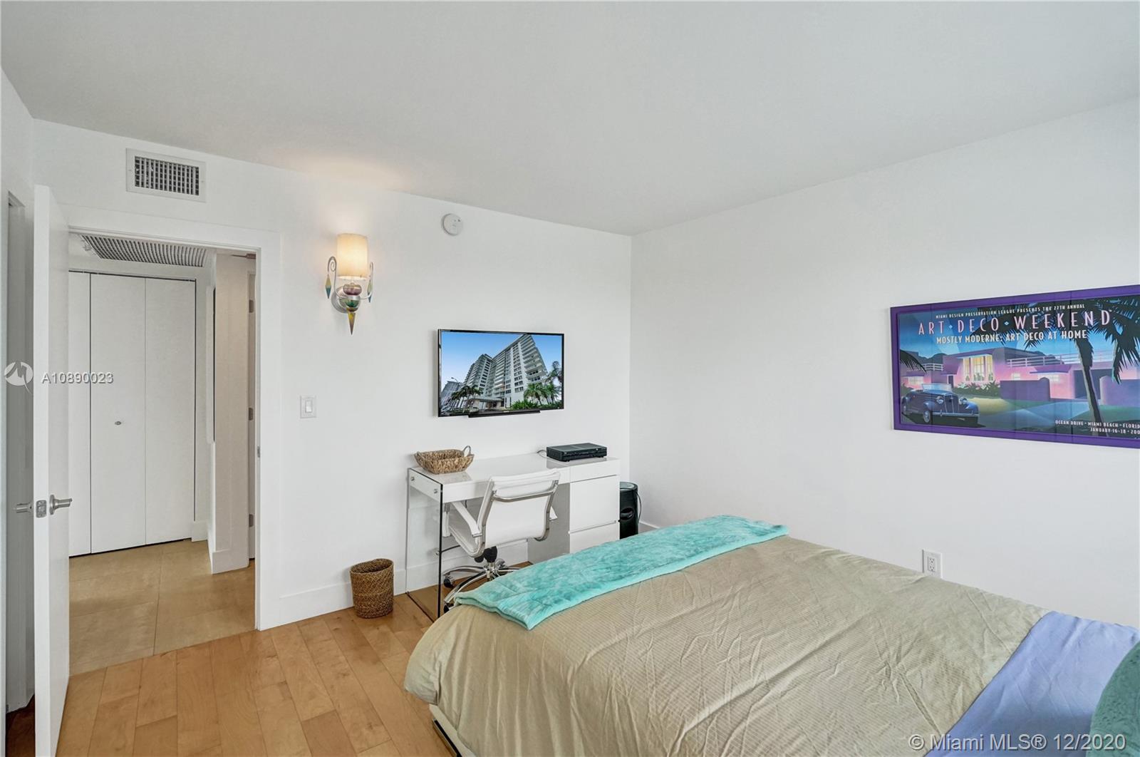 5750 Collins Avenue, Unit 15F Miami Beach, FL 33140 - Photo 30 of 65 a bedroom with a bed and a wall painting