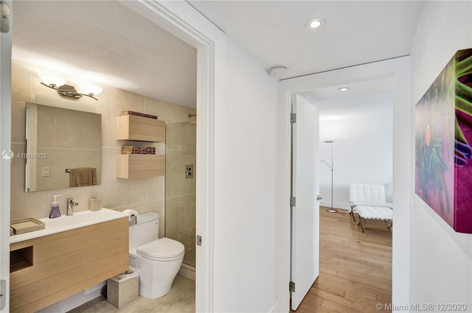 5750 Collins Avenue, Unit 15F Miami Beach, FL 33140 - Photo 32 of 65 a bathroom with a sink a toilet and shower