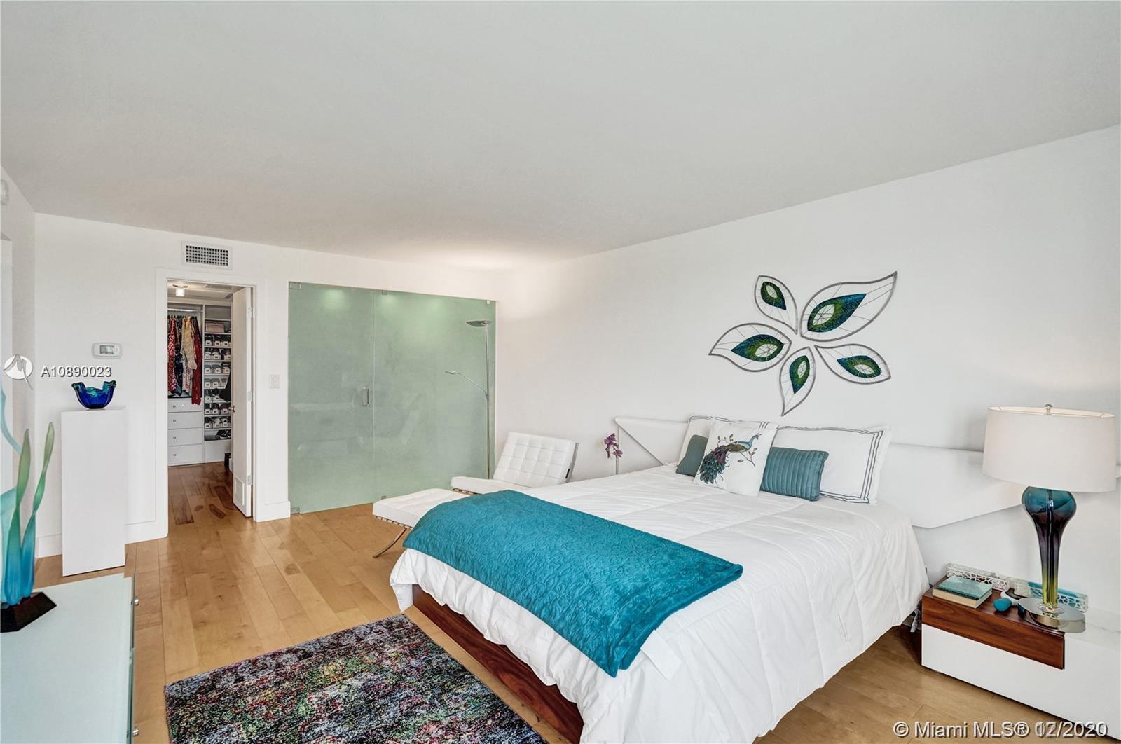 5750 Collins Avenue, Unit 15F Miami Beach, FL 33140 - Photo 35 of 65 a bedroom with a bed and a view of bathroom